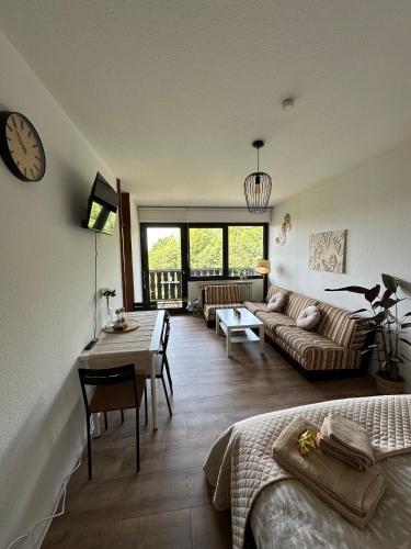 a living room with a couch and a table at Schmuckkästle in Sasbachwalden