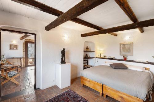 a bedroom with a bed in a room with wooden ceilings at The Gallery - Unità 16 in Baiardo