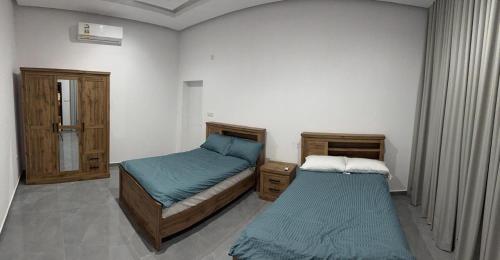 a bedroom with two beds in a room at Al REEF in Billah