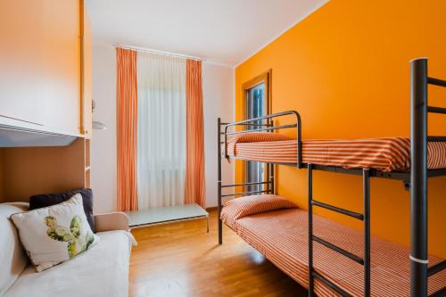 a room with two bunk beds and a couch at Stella Maris a Porto Cesareo in Porto Cesareo