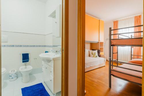 a bathroom with a sink and a bunk bed at Stella Maris a Porto Cesareo in Porto Cesareo