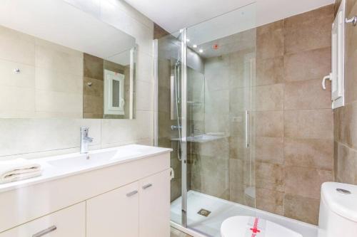 a bathroom with a shower and a sink and a toilet at Playamar in Alcudia
