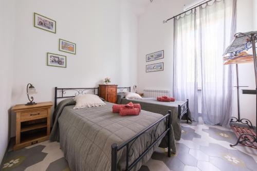 a bedroom with two beds with red pillows on them at La Casa Bianca in Lipari
