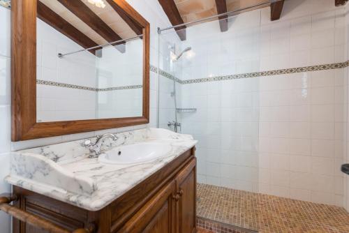 a bathroom with a sink and a mirror at Can Llobera in Pollença