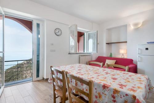a bedroom with a bed and a kitchen and a balcony at Casa mare montaretto 2 in Bonassola