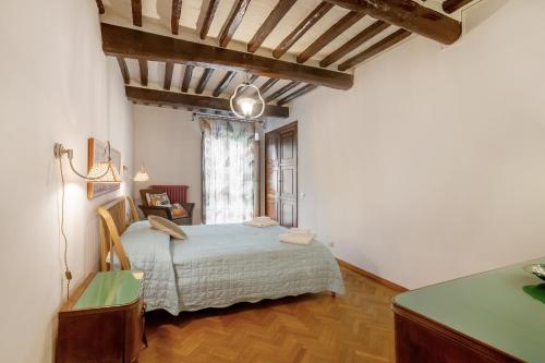 a bedroom with a bed and a large window at Il Tuo Posto A Greve In Chianti in Greve in Chianti