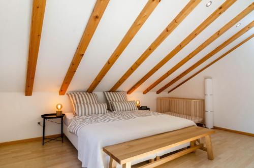 a bed in a room with wooden beams at Enjoy mal - Apartments in Stockach