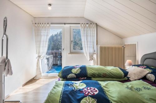a room with a bed and a couch and a window at Villa Sonnenwinkel in Todtmoos