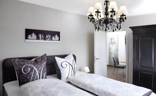a bedroom with a bed and a chandelier at Panorama in Ibach