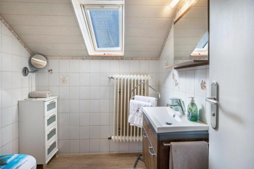 a small bathroom with a sink and a refrigerator at Villa Sonnenwinkel in Todtmoos