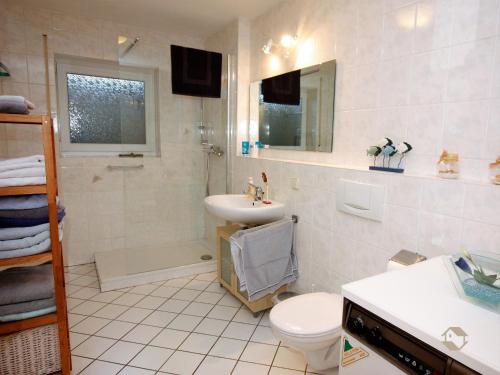 a white bathroom with a sink and a toilet at Ferienwohnung Linder in Schömberg