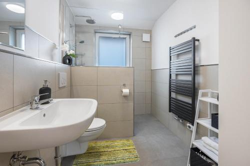 a bathroom with a sink and a toilet at Kroge Apartment in Uelzen