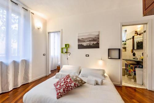a bedroom with a white bed with two pillows on it at la vigna del Vescovo in Verona