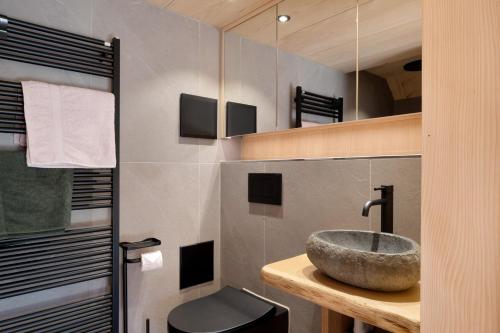 a bathroom with a sink and a toilet at Schwarzwaldchalet Holzperle in Lenzkirch