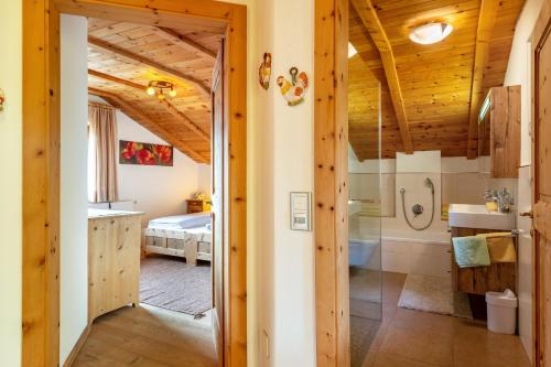 a bathroom with a shower and a bed in a room at Malsötscherhof Apt C in Villandro
