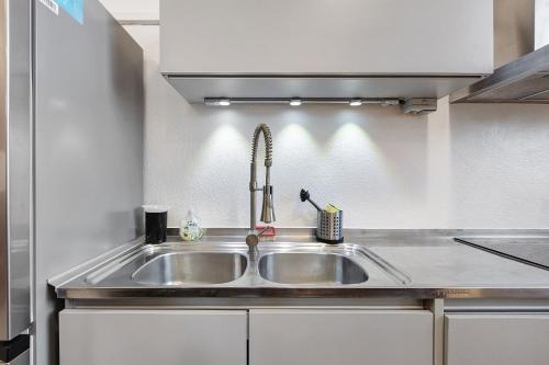 a kitchen with a stainless steel sink in a kitchen at Ferienwohnung Atelier in Schopfheim