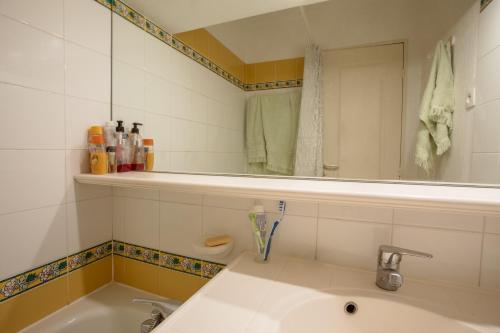 a bathroom with a sink and a mirror at Restanques de Saint Tropez - arums in Grimaud