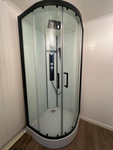 a glass shower in a corner of a room at Mysig Stuga in Sveg