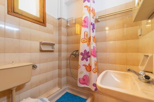 a bathroom with a sink and a toilet and a shower at Mires House Side Ground Floor 3 in Agios Gordios