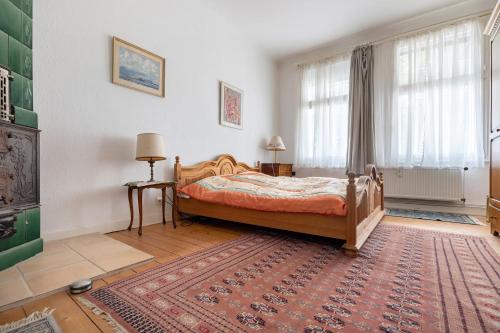 a bedroom with a bed and a rug at Grosszügiges Ferienhaus mit Wald in Gerdau