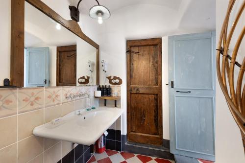 a bathroom with a sink and a mirror at Agriturismo Bricco in Finale Ligure
