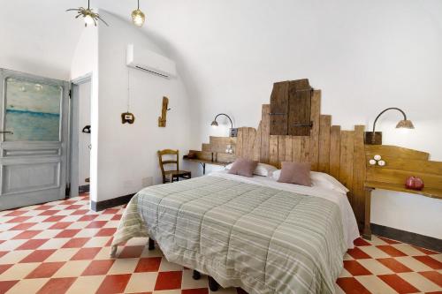 a bedroom with a bed and a checkered floor at Agriturismo Bricco in Finale Ligure