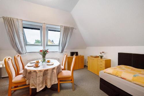 a room with a table and chairs and a bed at Ferienwohnung Küstenstübchen Gruse in Bartenshagen-Parkentin