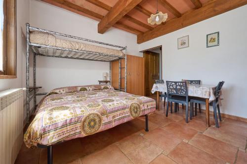 a bedroom with a bed and a table and chairs at Podere Chinco - Gavorrano in Gavorrano