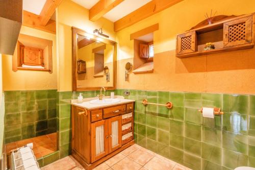a bathroom with a sink and a mirror at Cal Viudet in Caserras