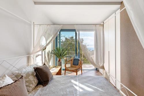a bedroom with a bed and a large window at Saint Claude in Marina di Andora