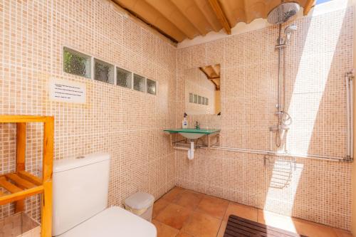 a bathroom with a shower and a toilet and a sink at Bona Mar in Cala Ratjada