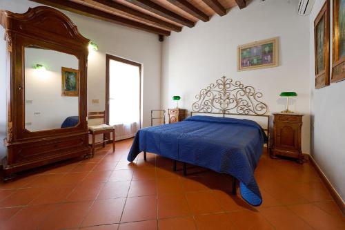 a bedroom with a bed and a large mirror at Poggio Diavolino - Suvereto in Suvereto