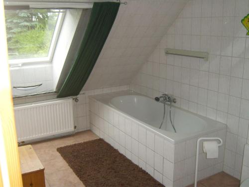 a bath tub in a bathroom with a window at Ferienwohnung Kelpin in Möllenbeck