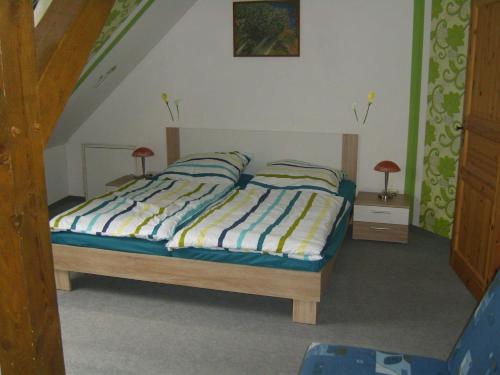 a bedroom with a bed with two pillows on it at Ferienwohnung Kelpin in Möllenbeck