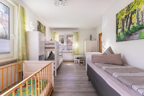 a dorm room with two beds and a crib at Ferienhaus von Osten in Burg