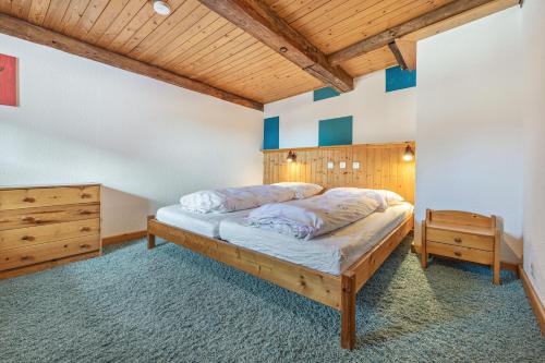 a bedroom with a bed and a wooden ceiling at Ferienwohnung Spormann in Braunlage