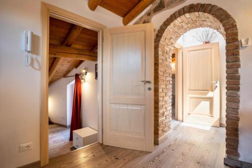 an open door in a room with a brick wall at Appartamento Gufo in Tremosine Sul Garda