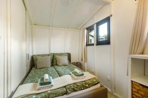 a small bed in a small room with towels on it at Berghütte in Ulrichstein