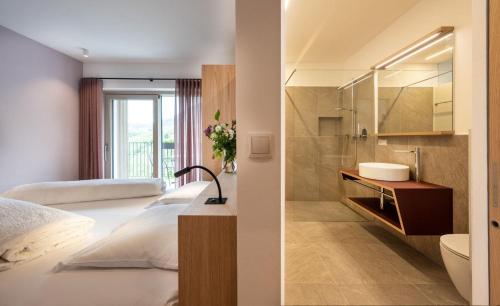 a hotel room with a bed and a bathroom at Gostnerhof Barbian in Barbiano