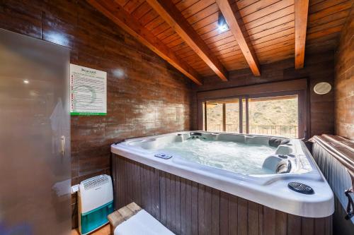a large bath tub in a room with wooden walls at Tenguerengue in Laroya