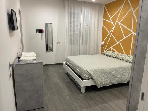 a bedroom with a bed and a mirror at Il Paradiso Holiday in Ravenna