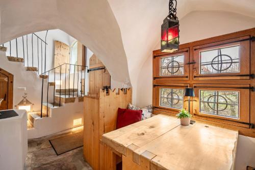 a room with a wooden table and some windows at Apartment Zwiefirst in Grafing