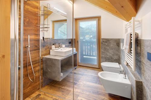 a bathroom with a sink and a toilet and a shower at Olympic Chalet 12 in Bormio