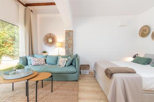 a living room with a bed and a couch at Bacom Apartment in Caldes de Malavella