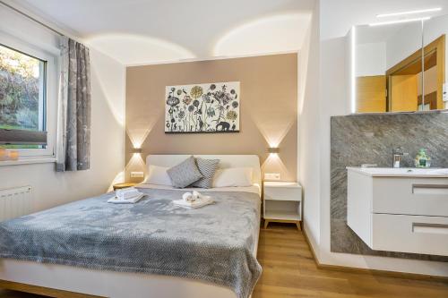 a small bedroom with a bed and a sink at Ferienwohnung Edelstein in Neukirchen am Großvenediger