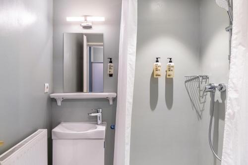 a bathroom with a sink and a toilet and a mirror at Chalet Sonneck - Seefeld in Seefeld in Tirol