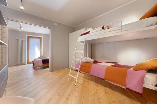 a bedroom with a bunk bed with a ladder at Palazzo Righi in Carisolo