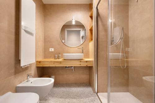 a bathroom with a toilet sink and a mirror at Palazzo Righi in Carisolo