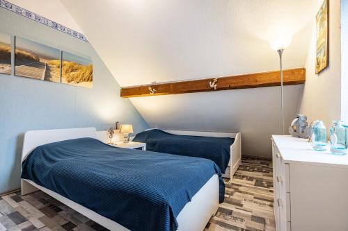 a room with two beds and a sink in it at Ferienwohnung Albatros Steinhude in Wunstorf