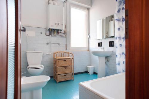 a bathroom with a white toilet and a sink at Casa Bruno e Iris in Levanto
